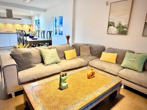 a living room with a couch and a table at Famara ocean view house in Famara