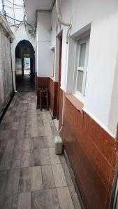 an empty hallway of a building with a broom at La casa de Samuel in San Ramón de la Nueva Orán