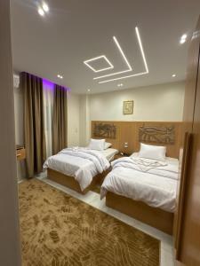 a hotel room with two beds in a room at Unique Pyramids Boutique INN in Cairo