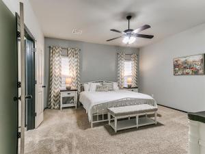 a bedroom with a bed and a ceiling fan at Spacious Deer Creek Home with Study and Yard in Edmond