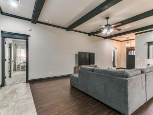 a living room with a couch and a ceiling fan at Spacious Deer Creek Home with Study and Yard in Edmond