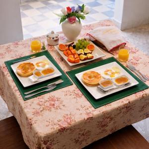 a table with two plates of breakfast food on it at Palacio Asteria in Torotoro