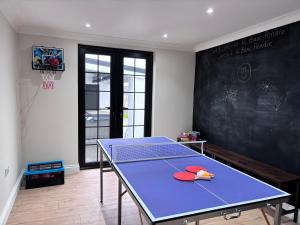 a ping pong table in a room with a chalkboard at 12 Banc Pendre in Kidwelly
