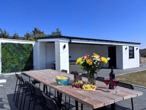 a wooden table with flowers and wine glasses at 12 Banc Pendre in Kidwelly