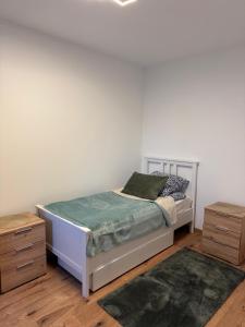 a bedroom with a bed and two night stands at Luxury Comfort Home in Anklam