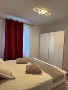 a bedroom with two beds and a red curtain at Luxury Comfort Home in Anklam