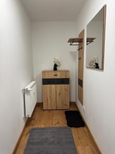 a hallway with a mirror and a wooden dresser at Luxury Comfort Home in Anklam