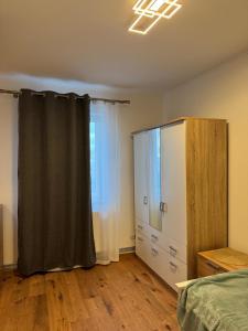 a bedroom with a bed and a dresser and a window at Luxury Comfort Home in Anklam +2 photos