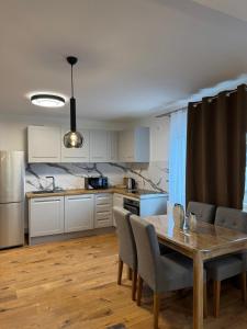 a kitchen with a table and chairs in a room at Luxury Comfort Home in Anklam
