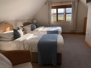 a hotel room with three beds and a window at Lissadell Lodge in Carney +44 photos