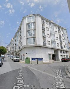 a large white building on the corner of a street at Aires do Masma in Foz