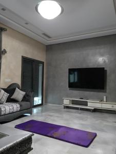 a living room with a couch and a tv at Apartment in Tanger in Tangier