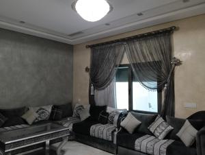 a living room with two couches and a window at Apartment in Tanger in Tangier