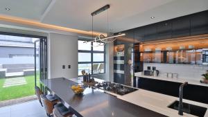 a kitchen with a large island with a counter top at Pops lifestyle in Sandton