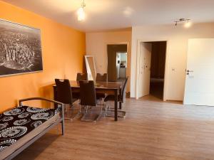 a dining room with a table and chairs at StayHere24 Große Monteur- und Ferienwohnung am Auenwald in Schkeuditz +18 photos