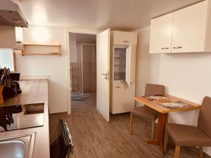 a small kitchen with a table and a dining room at StayHere24 Große Monteur- und Ferienwohnung am Auenwald in Schkeuditz