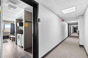 an office corridor with a door leading to a room at Apartment in Gautefall in Drangedal