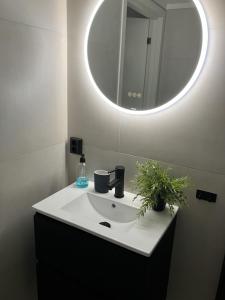 a bathroom with a white sink and a mirror at Apartment in Gautefall in Drangedal +17 photos