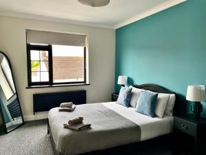 a bedroom with a bed with two towels on it at 12 Banc Pendre in Kidwelly