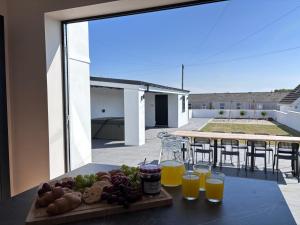 a tray of fruit on a table with glasses of orange juice at 12 Banc Pendre in Kidwelly