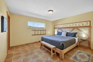 a bedroom with a king sized bed in a room at Creekside Juanita's Place - 51 E 200 in Moab