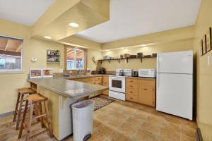 a kitchen with a white refrigerator and a counter at Creekside Juanita's Place - 51 E 200 in Moab