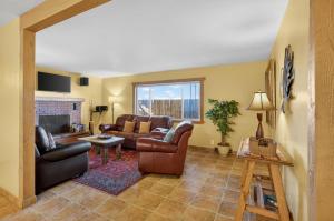 a living room with leather furniture and a fireplace at Creekside Juanita's Place - 51 E 200 in Moab