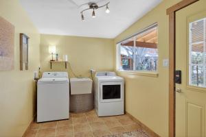 a laundry room with two washing machines and a window at Creekside Juanita's Place - 51 E 200 in Moab +17 photos