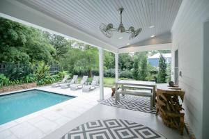 a patio with a pool and a table and chairs at Marée Mason in Ocean Springs