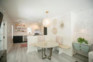 a kitchen with a table and a dining room at Marée Mason in Ocean Springs