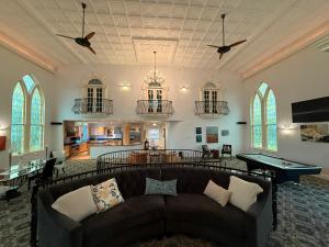 a living room with a couch and a pool table at Belfry Inn and Bistro in Sandwich