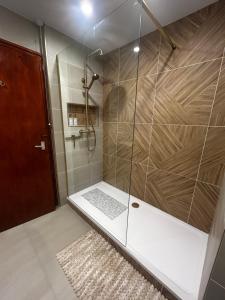 a shower with a glass door in a bathroom at Shirleys apartment in Rhyl