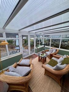 a room with wicker chairs and couches on a house at Snowdon Retreat in Llanberis