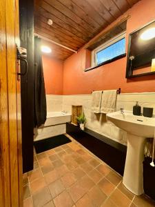 a bathroom with a sink and a tub at Snowdon Retreat in Llanberis
