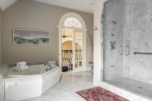 a white bathroom with a tub and a shower at Belfry Inn and Bistro in Sandwich +84 photos
