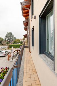 a balcony of a building with flowers on it at SYC I Mulini, Leonardo Academy & MXP & JRC Ispra in Sesto Calende