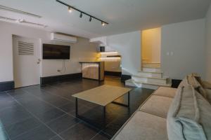 a living room with a couch and a table at Casa Palma in Medellín
