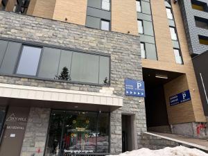 a store front of a brick building with windows at SkyHill Jahorina Gondola Poljice Newly Opened in Jahorina