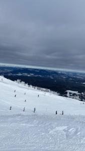 a group of people skiing down a snow covered slope at SkyHill Jahorina Gondola Poljice Newly Opened in Jahorina