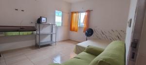 a living room with a couch and a window at Kitnet na Imbiribeira in Recife