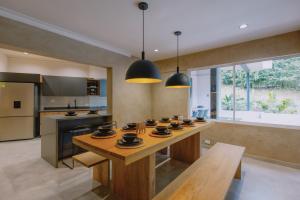 a kitchen with a table with cups on it at Casa Palma in Medellín