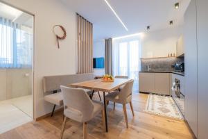 a kitchen and dining room with a table and chairs at Apartament Tre Cime in San Sigismondo