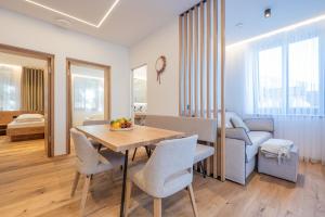 a living room and dining room with a table and chairs at Apartament Tre Cime in San Sigismondo