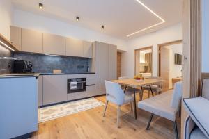 a kitchen and dining room with a table and chairs at Apartament Tre Cime in San Sigismondo +47 photos