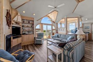 a large living room with couches and a tv at 3945 - Sea Lodge II in Duck