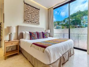 a bedroom with a bed and a large window at Maxwell Collection Romantic Zone in Puerto Vallarta +290 photos