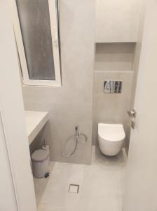 ein weißes Badezimmer mit Toilette und Waschbecken in der Unterkunft Urban Elegance in Larisa + 12 Fotos
