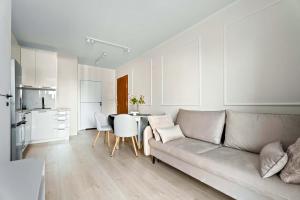 a living room with a couch and a table at MDM Apartments in Gdańsk +3 photos