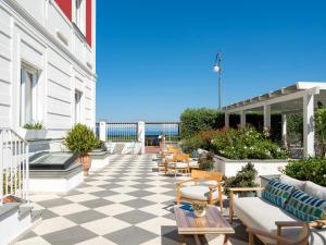 a patio with chairs and tables on a building at Hotel Villa Garden in Sant'Agnello