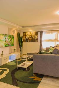 a living room with a couch and a table at Chic Modern Studio Apartment with Pool in Nanyuki +50 photos